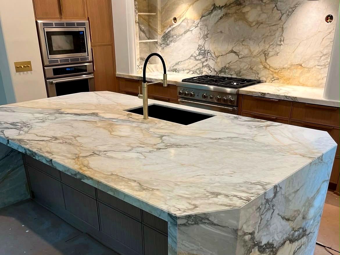 Custom marble waterfall island kitchen